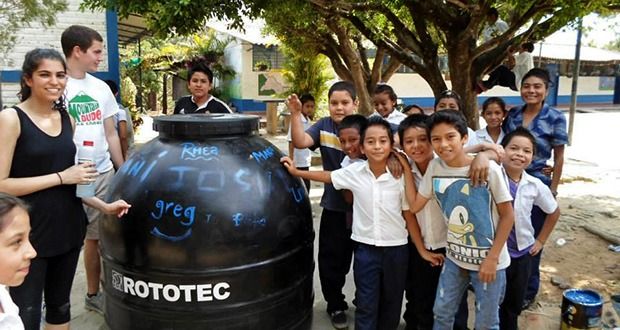 Pure Water Access Project members Rhea Malhotra and Greg Kemper work to bring clean water filters to a school in El Salvador this past March. Credit: Courtesy of PWAP